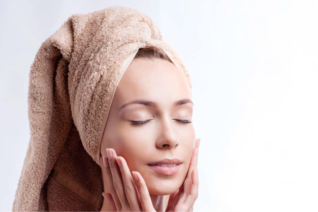 A women applying cream after shower